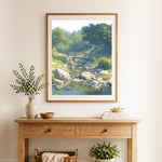 Finished serene creek bridge cross stitch artwork displayed as home decor