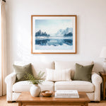 Finished serene frozen mountain lake cross stitch artwork displayed as home decor