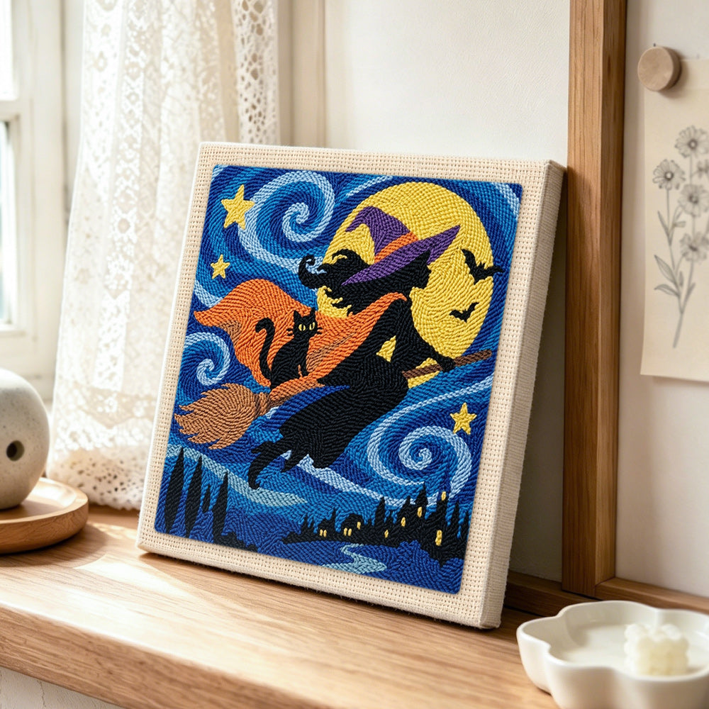 Silhouette witch night flight punch needle artwork displayed on a table