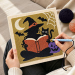 Creating handmade silhouette witch reading book punch needle artwork