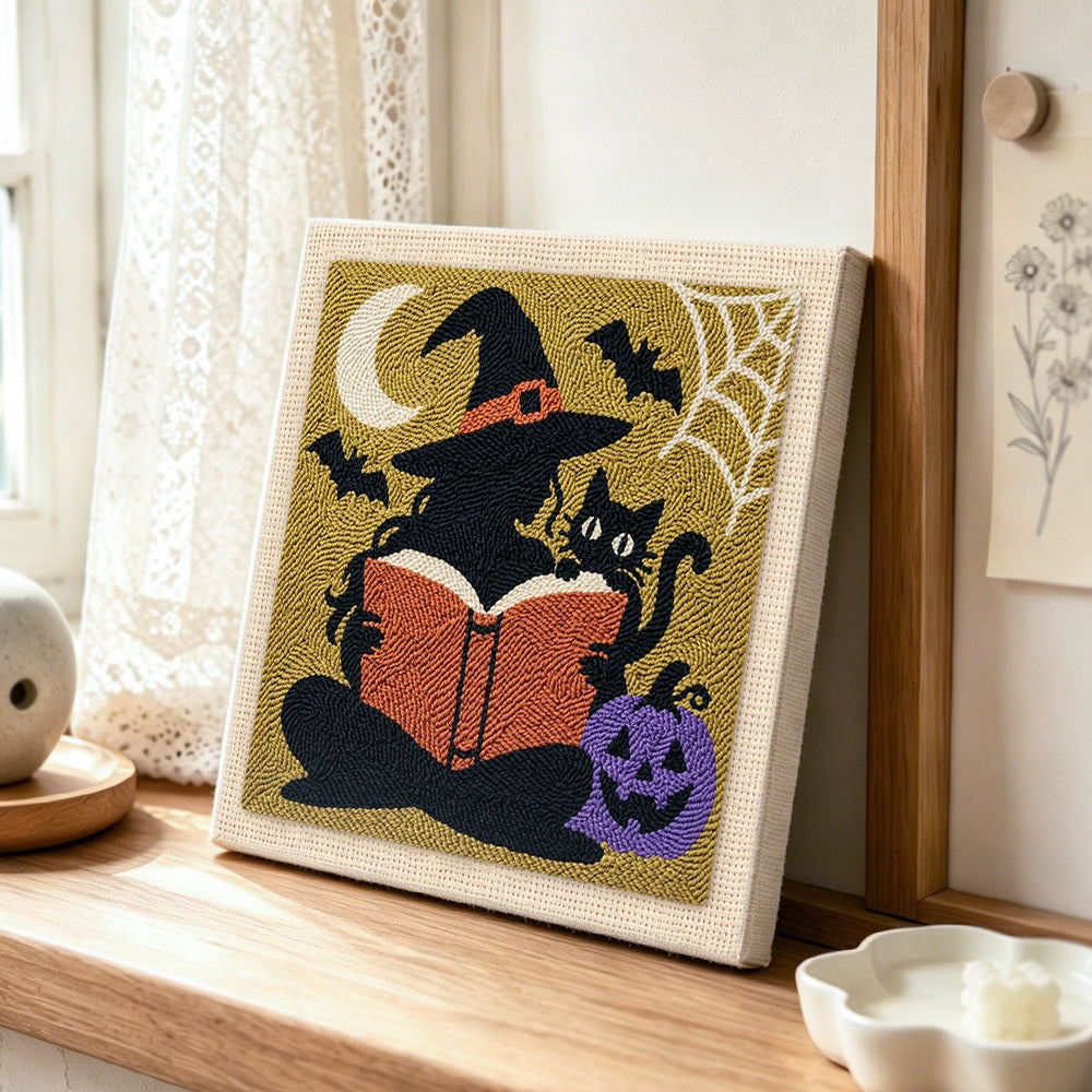 Silhouette witch reading book punch needle artwork displayed on a table