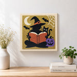 Finished silhouette witch reading book artwork displayed on a wall