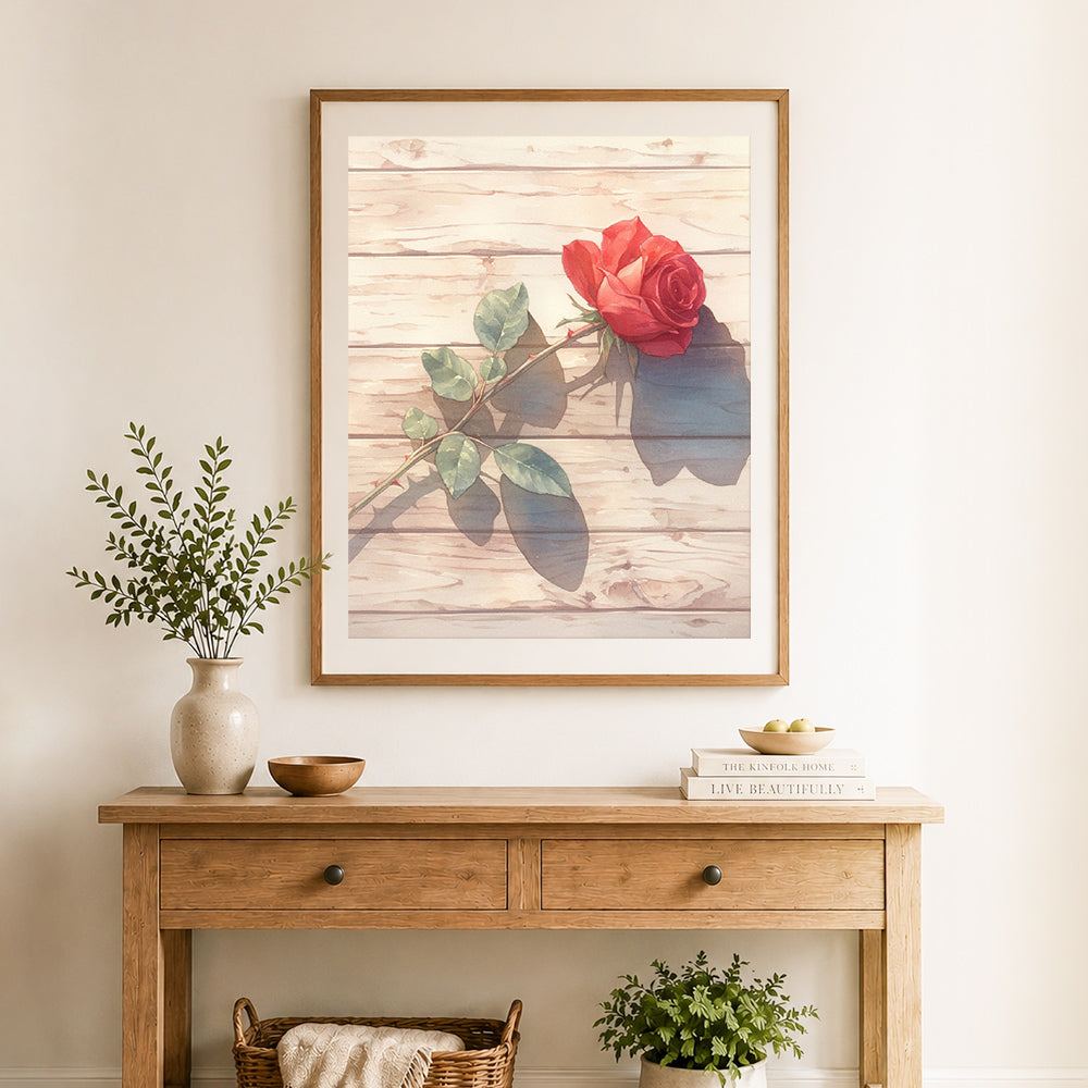 Finished single red rose cross stitch artwork displayed as home decor