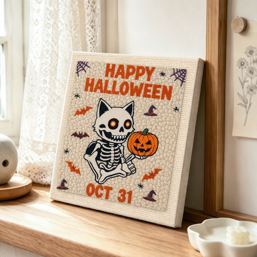 Skeleton cat and pumpkin punch needle artwork displayed on a table