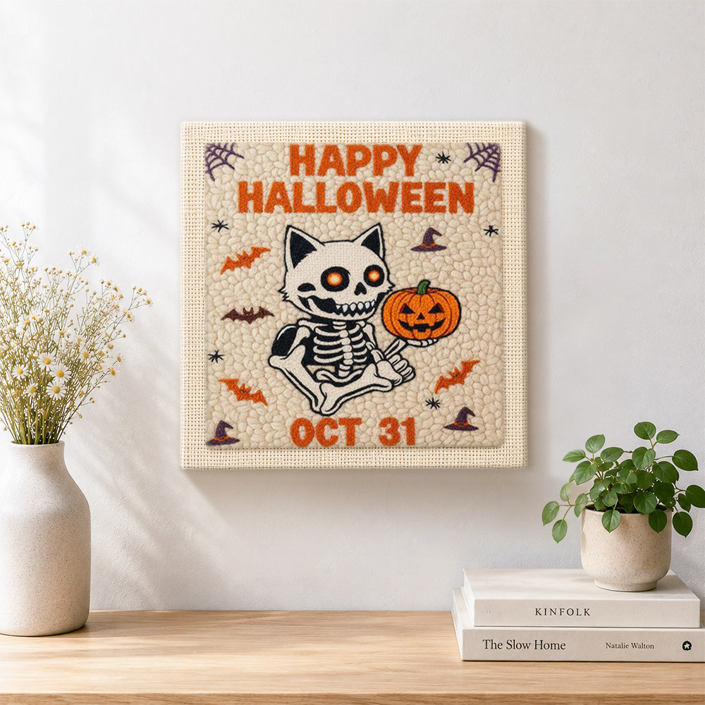 Finished skeleton cat and pumpkin artwork displayed on a wall