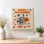 Finished skeleton cat and pumpkin artwork displayed on a wall