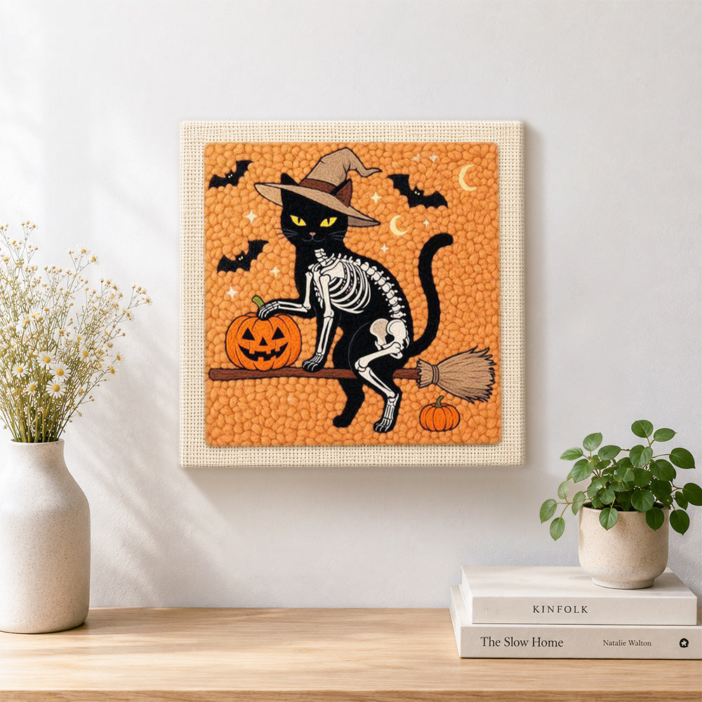 Finished skeleton cat on broomstick artwork displayed on a wall