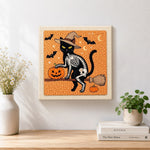 Finished skeleton cat on broomstick artwork displayed on a wall