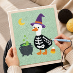 Creating handmade skeleton duck with witch hat punch needle artwork