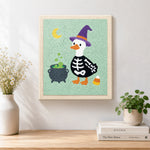 Finished skeleton duck with witch hat artwork displayed on a wall