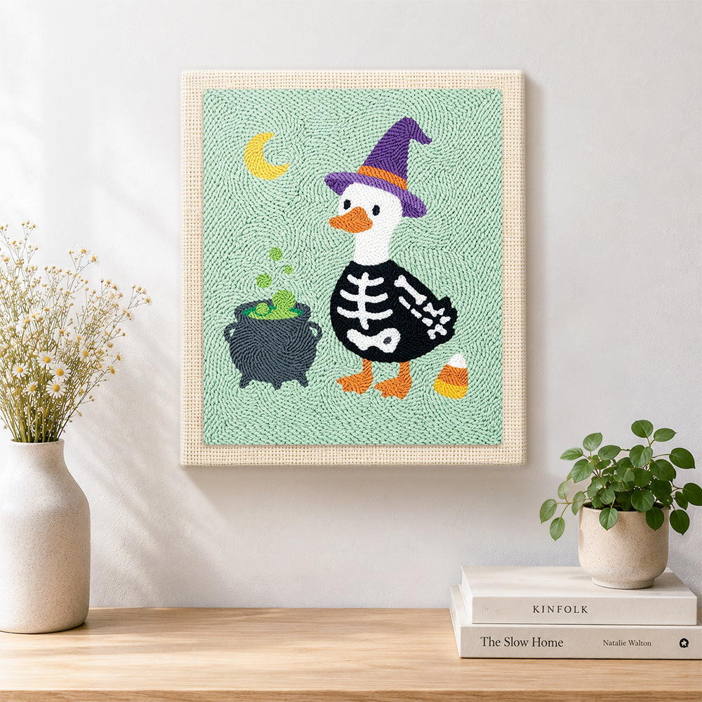 Finished skeleton duck with witch hat artwork displayed on a wall