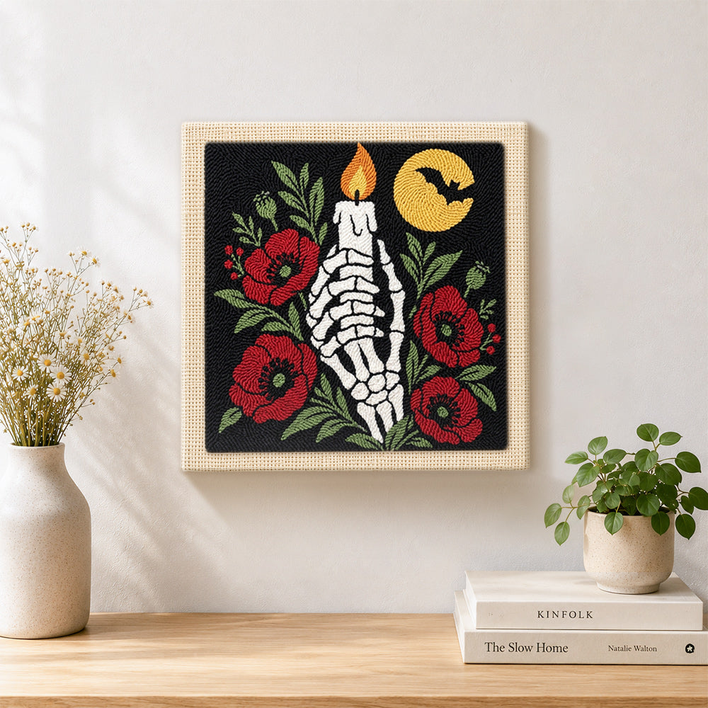 Finished skeleton hand with candle artwork displayed on a wall
