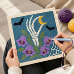 Creating handmade skeleton hand with purple bellflowers punch needle artwork