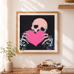 Finished skeleton holding a heart cross stitch artwork displayed as home decor