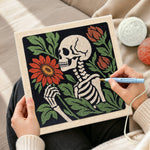 Creating handmade skeleton holding blooms punch needle artwork
