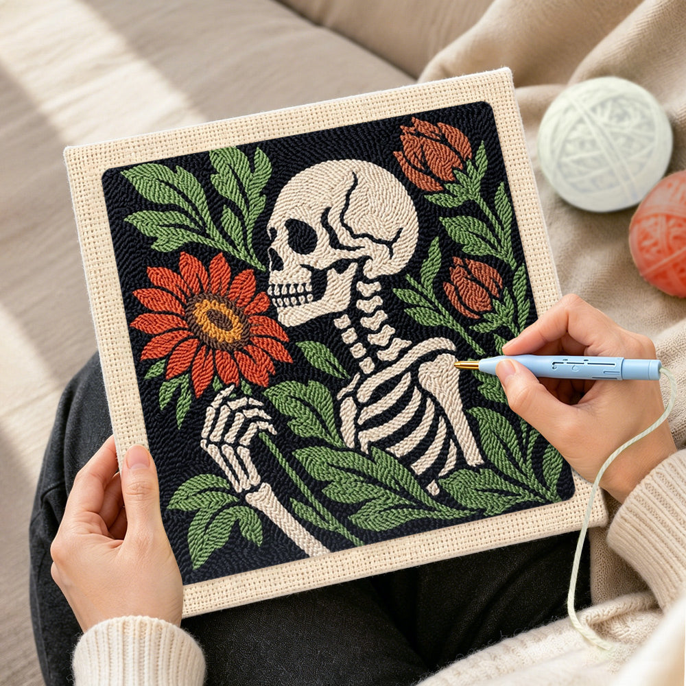 Creating handmade skeleton holding blooms punch needle artwork