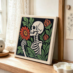Skeleton holding blooms punch needle artwork displayed on a table