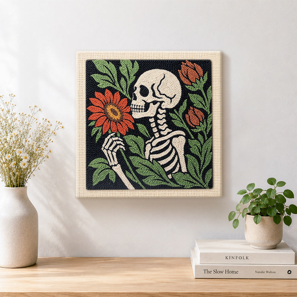 Finished skeleton holding blooms artwork displayed on a wall