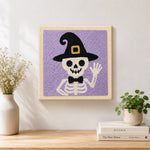 Finished skeleton in witch hat artwork displayed on a wall