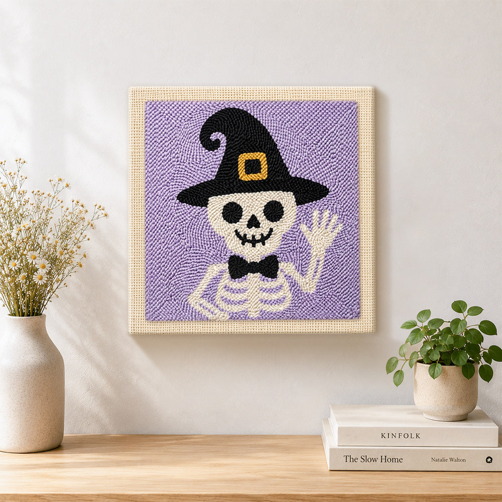 Finished skeleton in witch hat artwork displayed on a wall