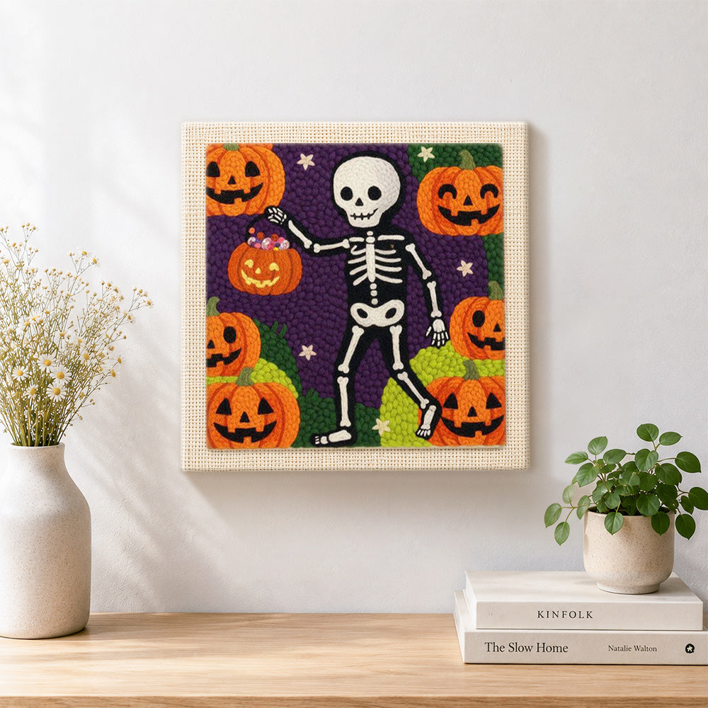 Finished skeleton pumpkin walk artwork displayed on a wall