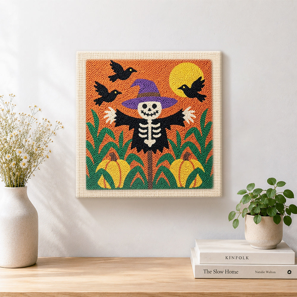 Finished skeleton scarecrow in pumpkin field artwork displayed on a wall