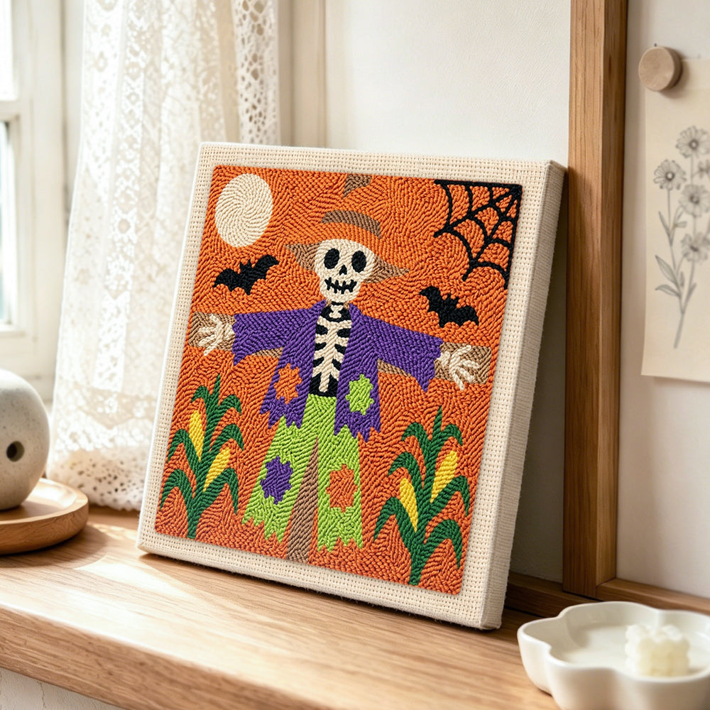 Skeleton scarecrow punch needle artwork displayed on a table