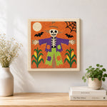 Finished skeleton scarecrow artwork displayed on a wall