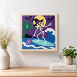 Finished skeleton witch paddle surfing artwork displayed on a wall