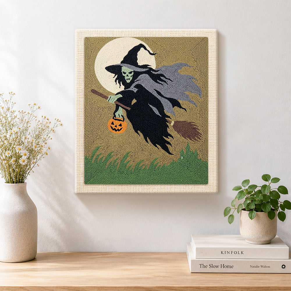 Finished skeleton witch with pumpkin lantern artwork displayed on a wall
