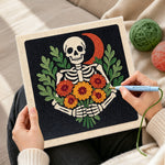 Creating handmade skeleton with marigolds punch needle artwork