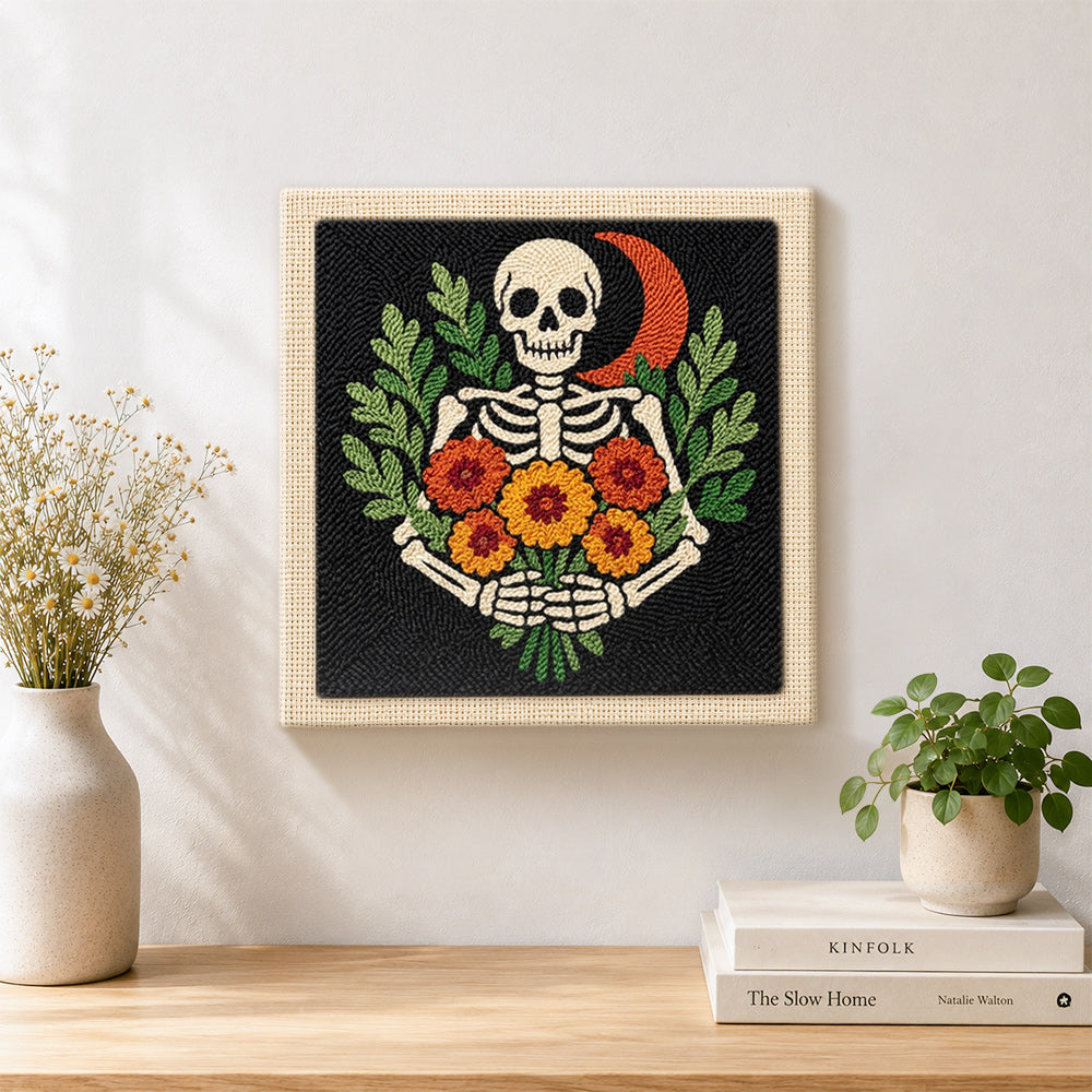 Finished skeleton with marigolds artwork displayed on a wall