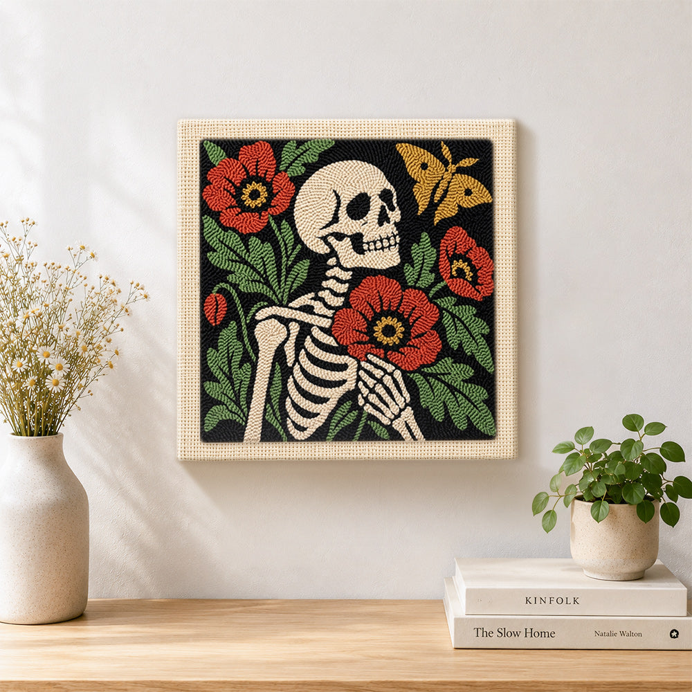 Finished skeleton with poppies and butterfly artwork displayed on a wall