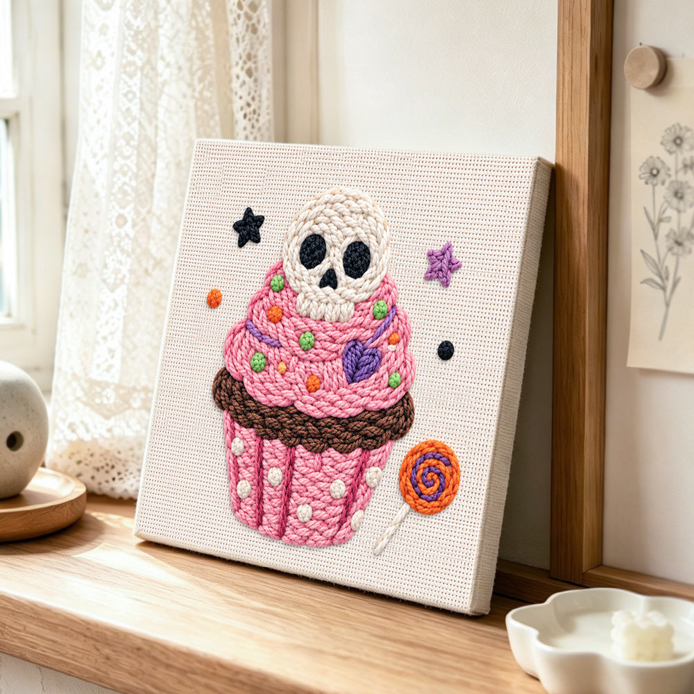 Skull cupcake treat punch needle artwork displayed on a table
