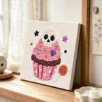 Skull cupcake treat punch needle artwork displayed on a table