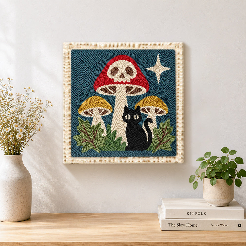 Finished skull mushroom and black cat artwork displayed on a wall