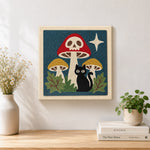 Finished skull mushroom and black cat artwork displayed on a wall