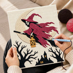 Creating handmade skull witch on broom punch needle artwork