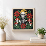 Finished skull with flowers and mushrooms artwork displayed on a wall