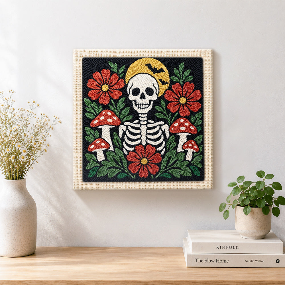 Finished skull with flowers and mushrooms artwork displayed on a wall
