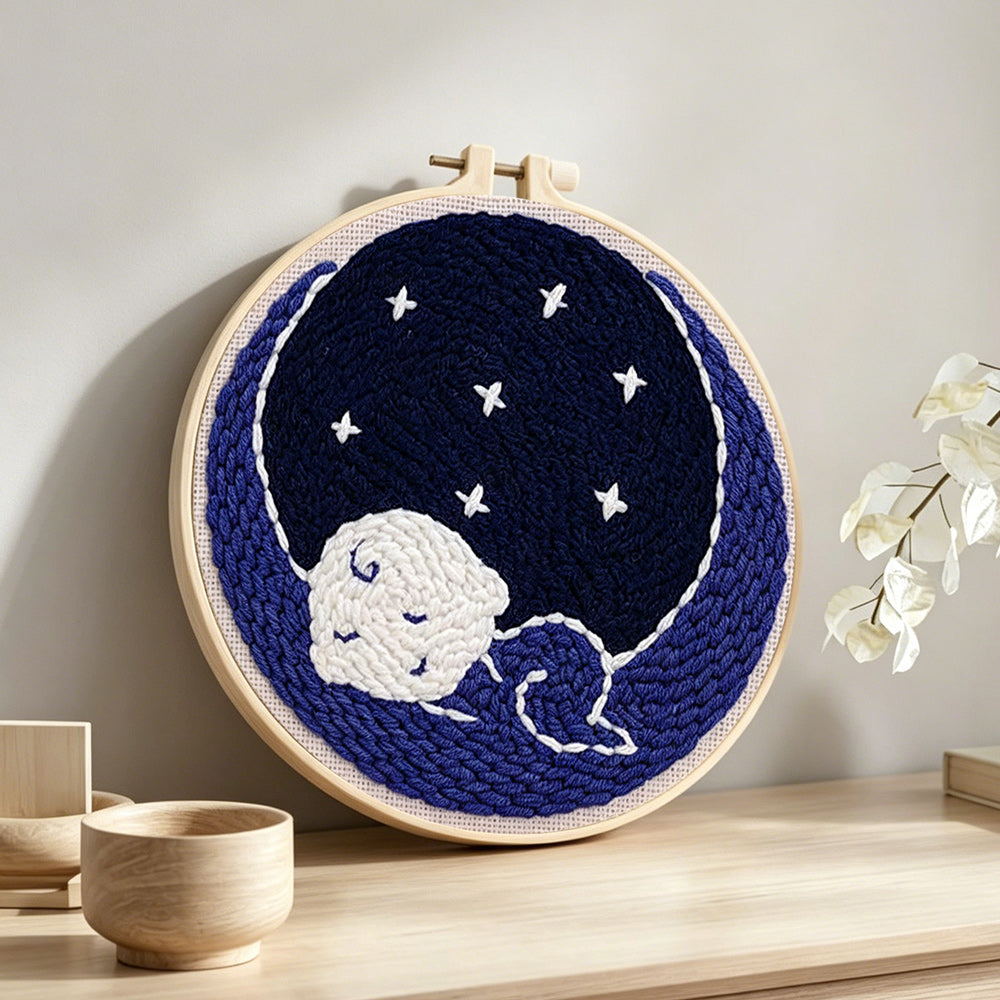 Sleeping baby punch needle artwork displayed on a table