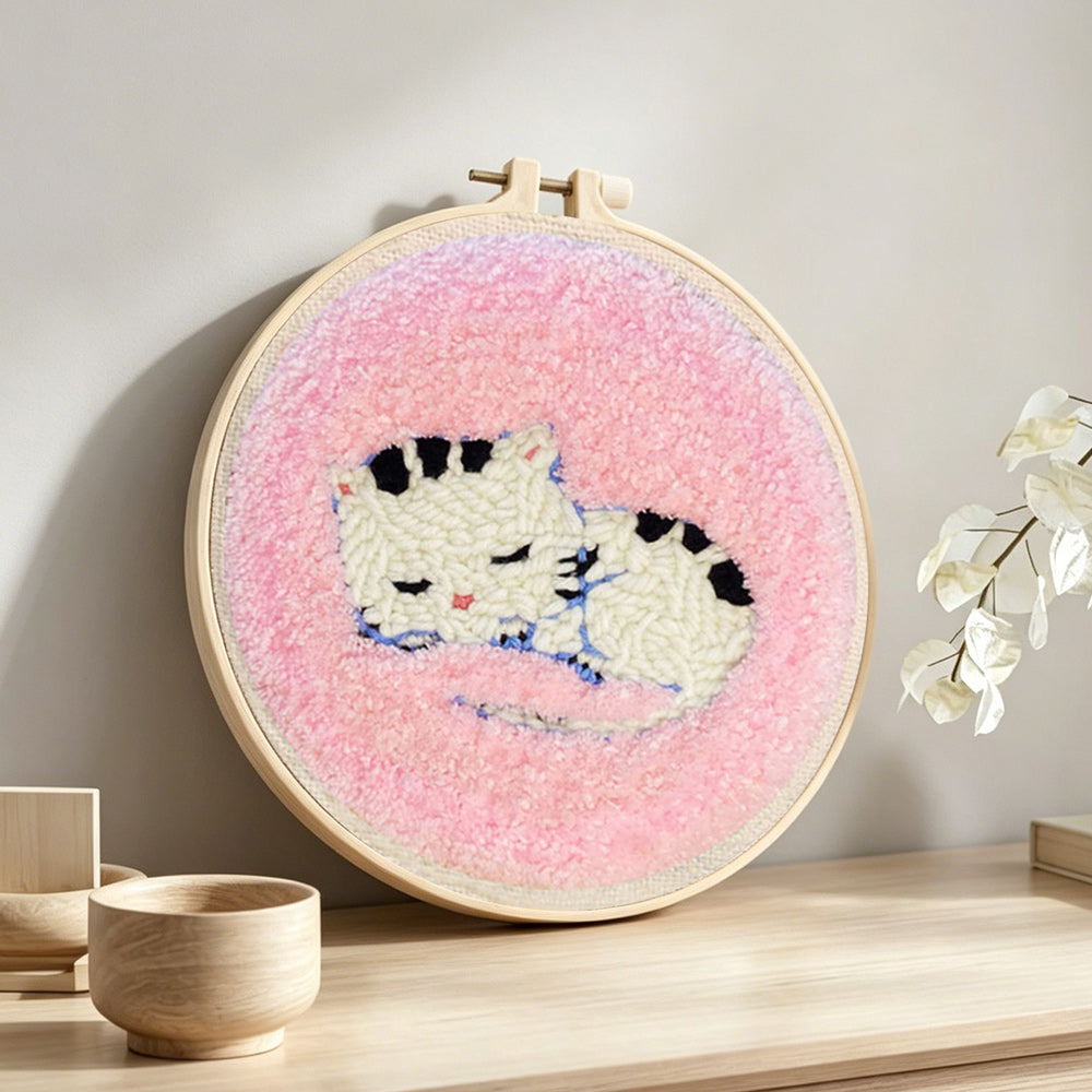 Sleeping kitten punch needle artwork displayed on a table