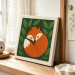 Sleeping woodland fox punch needle artwork displayed on a table