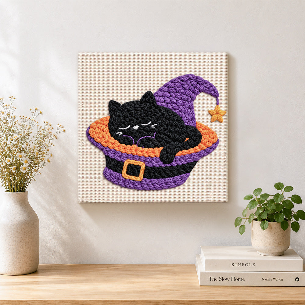 Finished sleepy black witch cat artwork displayed on a wall