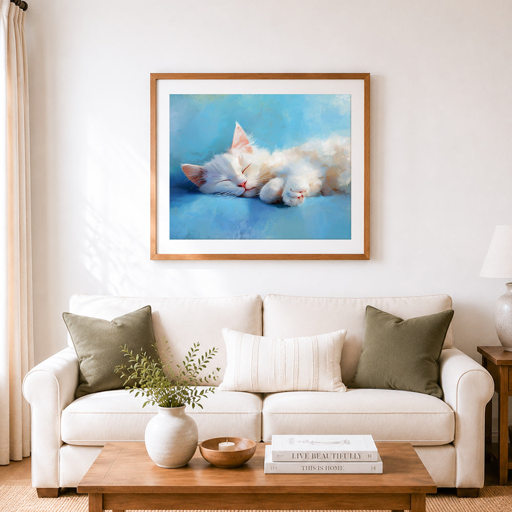 Finished sleepy fluffy white kitten cross stitch artwork displayed as home decor