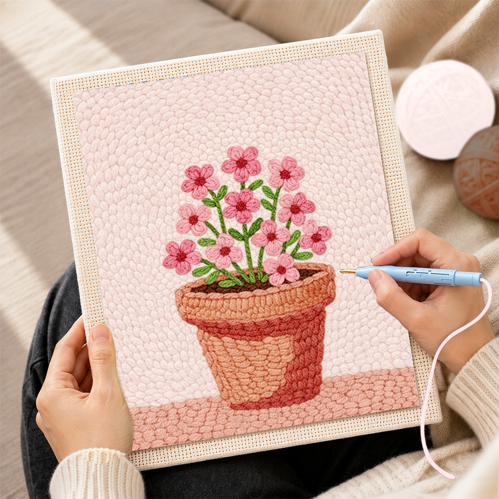 Creating handmade small pink flowers in pot punch needle artwork