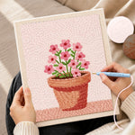 Creating handmade small pink flowers in pot punch needle artwork