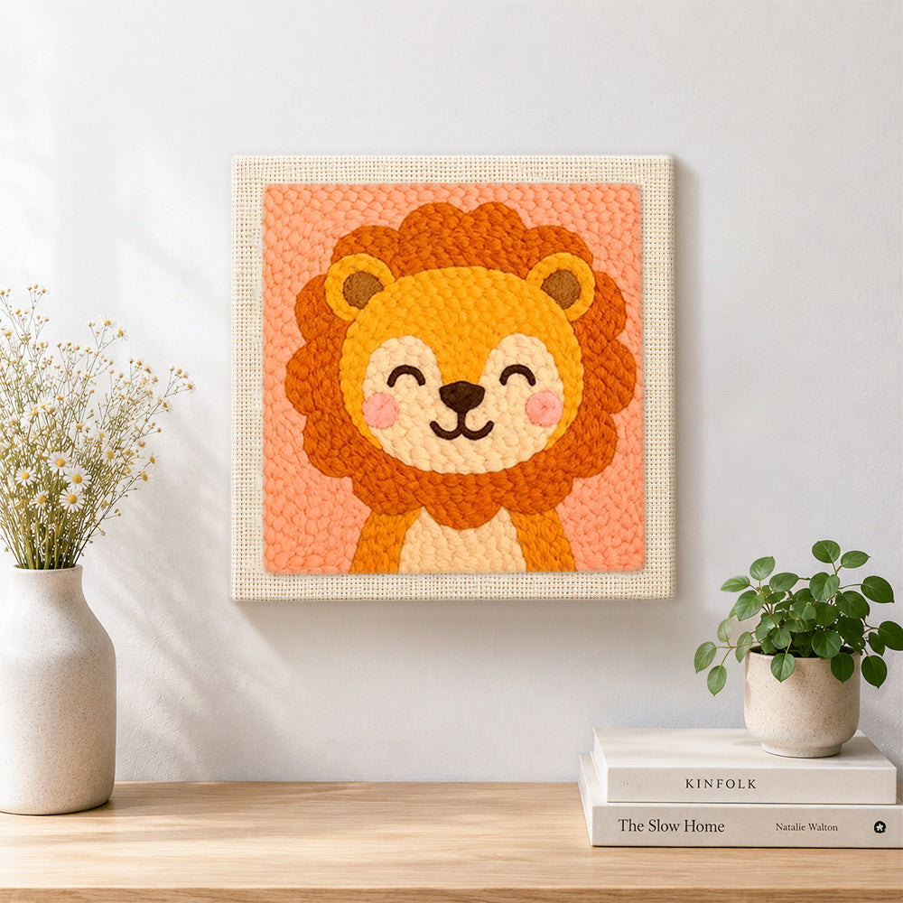 Finished smiling baby lion artwork displayed on a wall