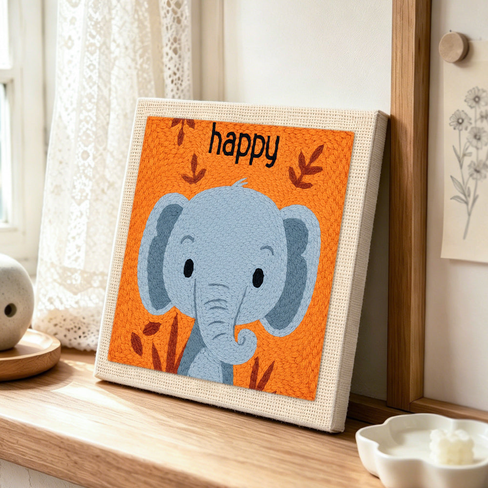 Smiling gray elephant punch needle artwork displayed on a table