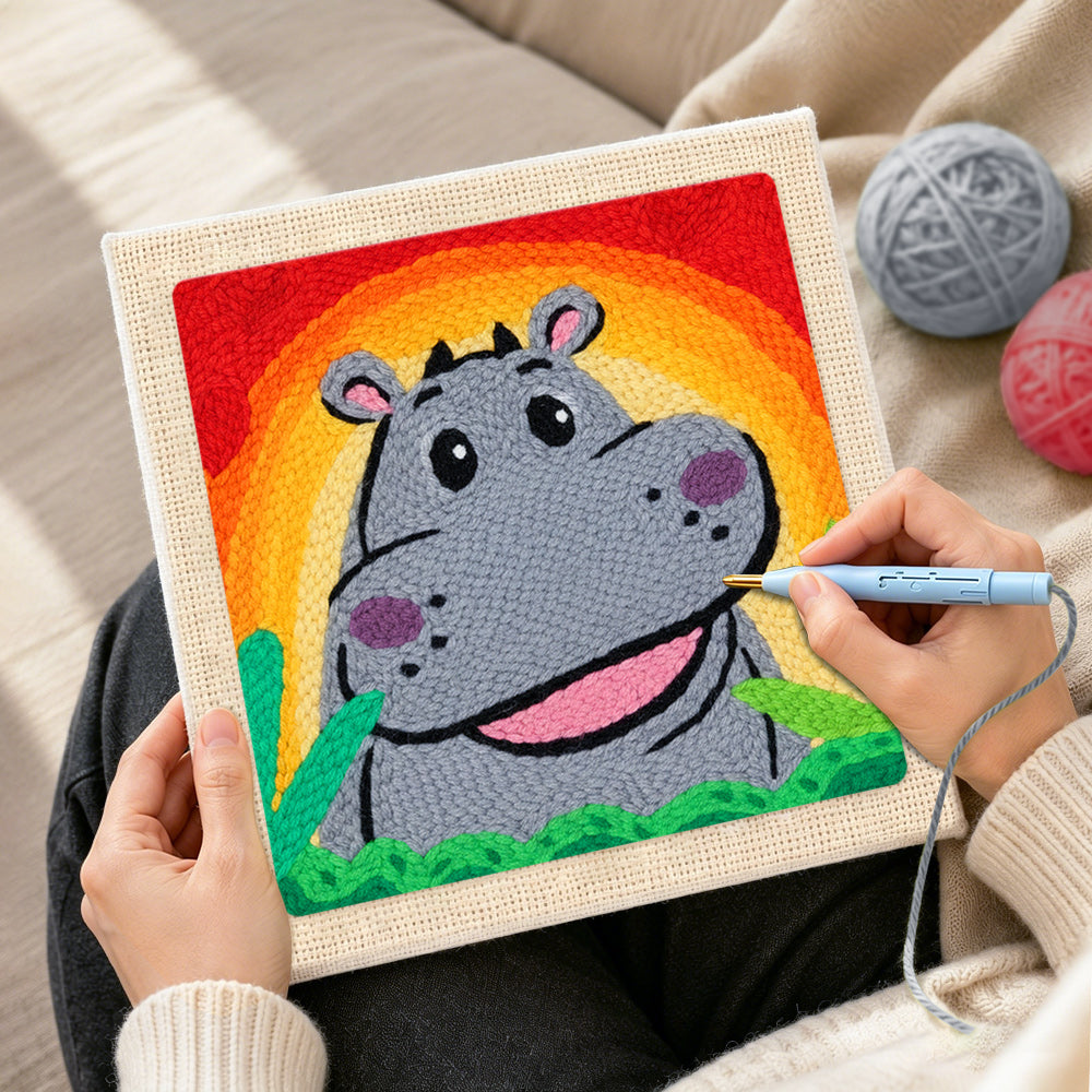 Creating handmade smiling gray hippo with rainbow sunset punch needle artwork